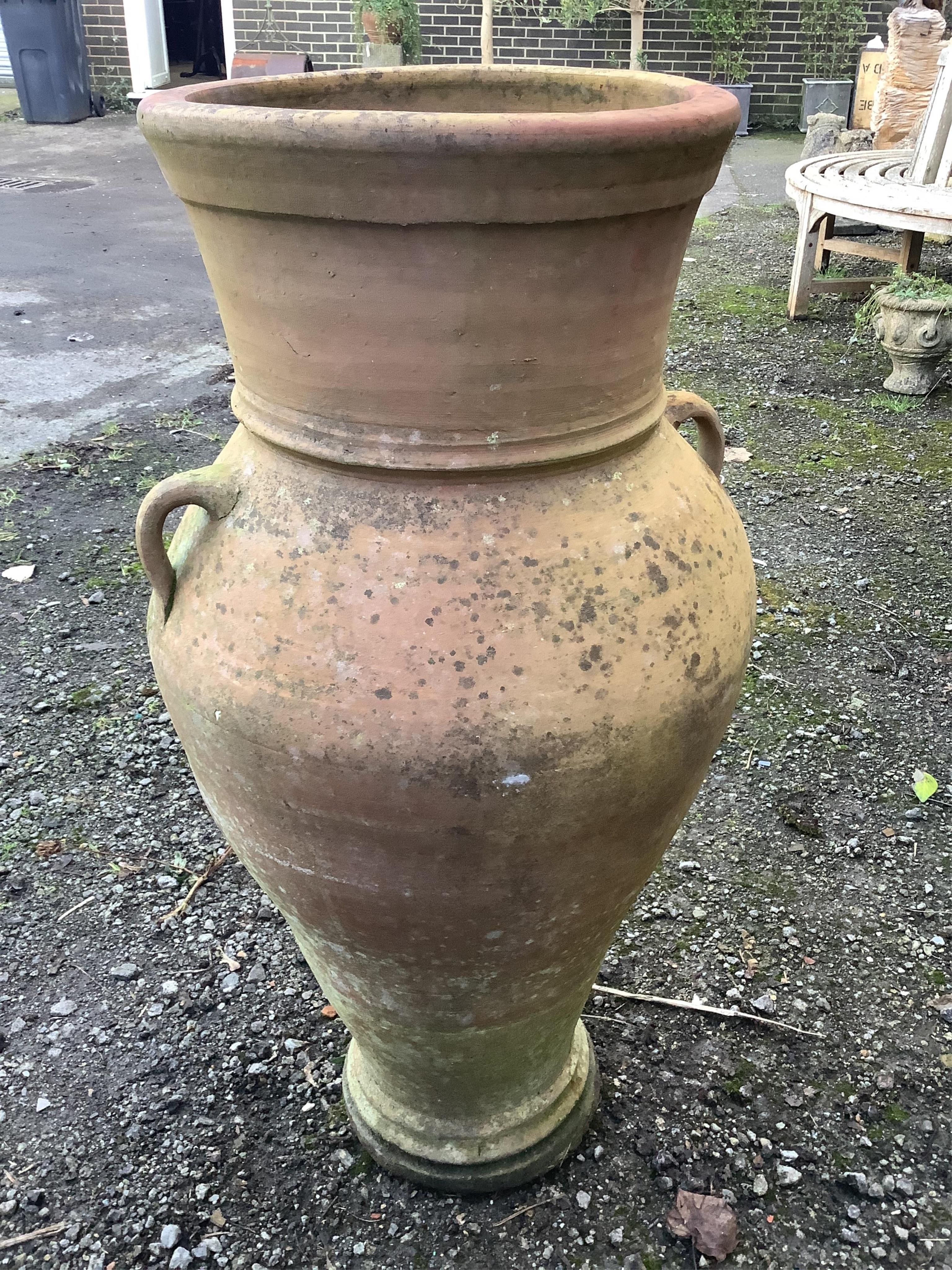 A Grecian style terracotta two handled garden urn, height 96cm. Condition - fair